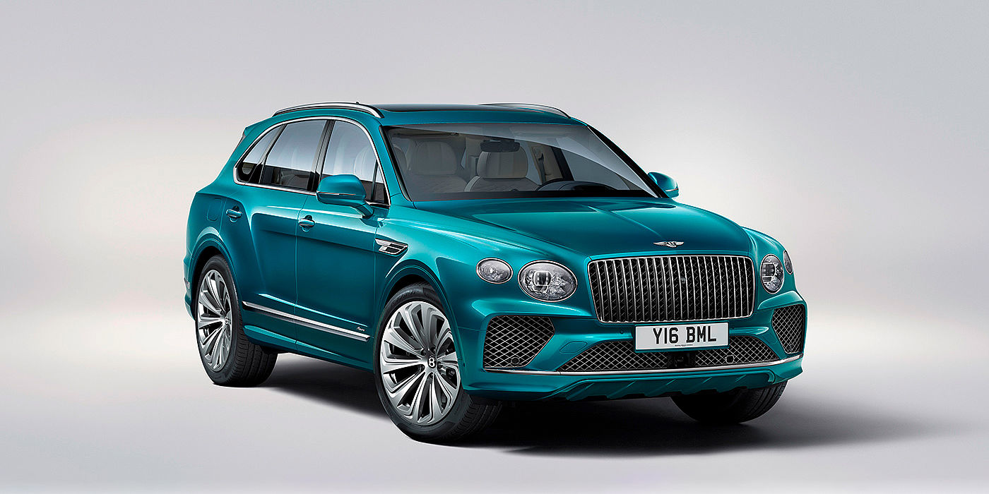Bentley Praha Bentley Bentayga Azure front three-quarter view, featuring a fluted chrome grille with a matrix lower grille and chrome accents in Topaz blue paint.