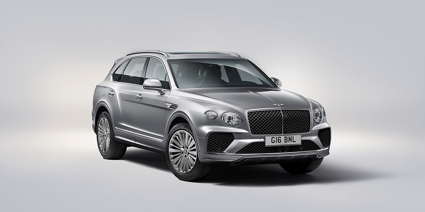 Bentley Praha Bentley Bentayga luxury SUV front three quarter view in Moonbeam paint with matrix grille and 21″ 5 spoke painted wheels