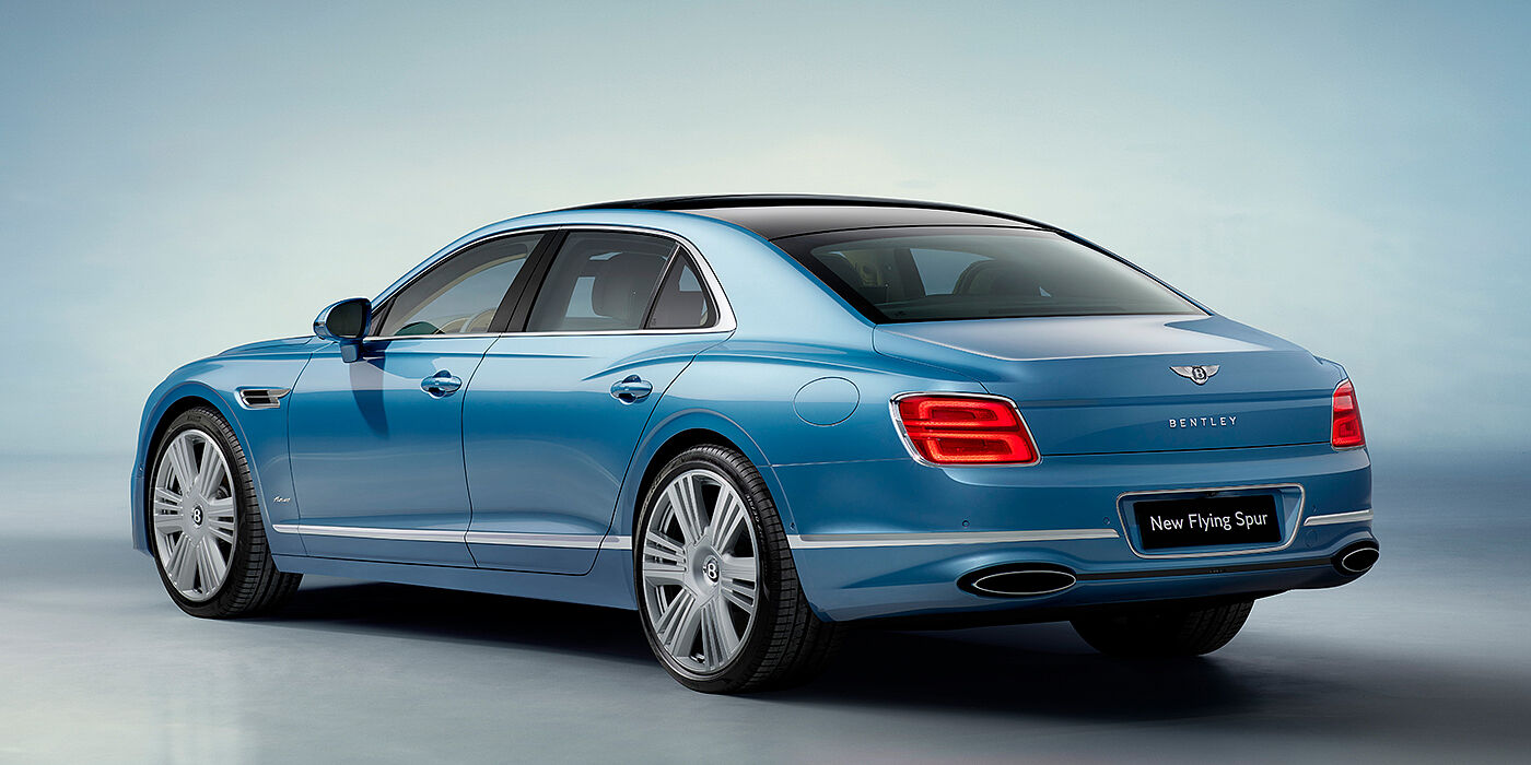 Bentley Praha New Bentley Flying Spur Azure sedan rear view in Light windsor blue by Mulliner paint with 22 inch Azure wheels and chrome exterior details