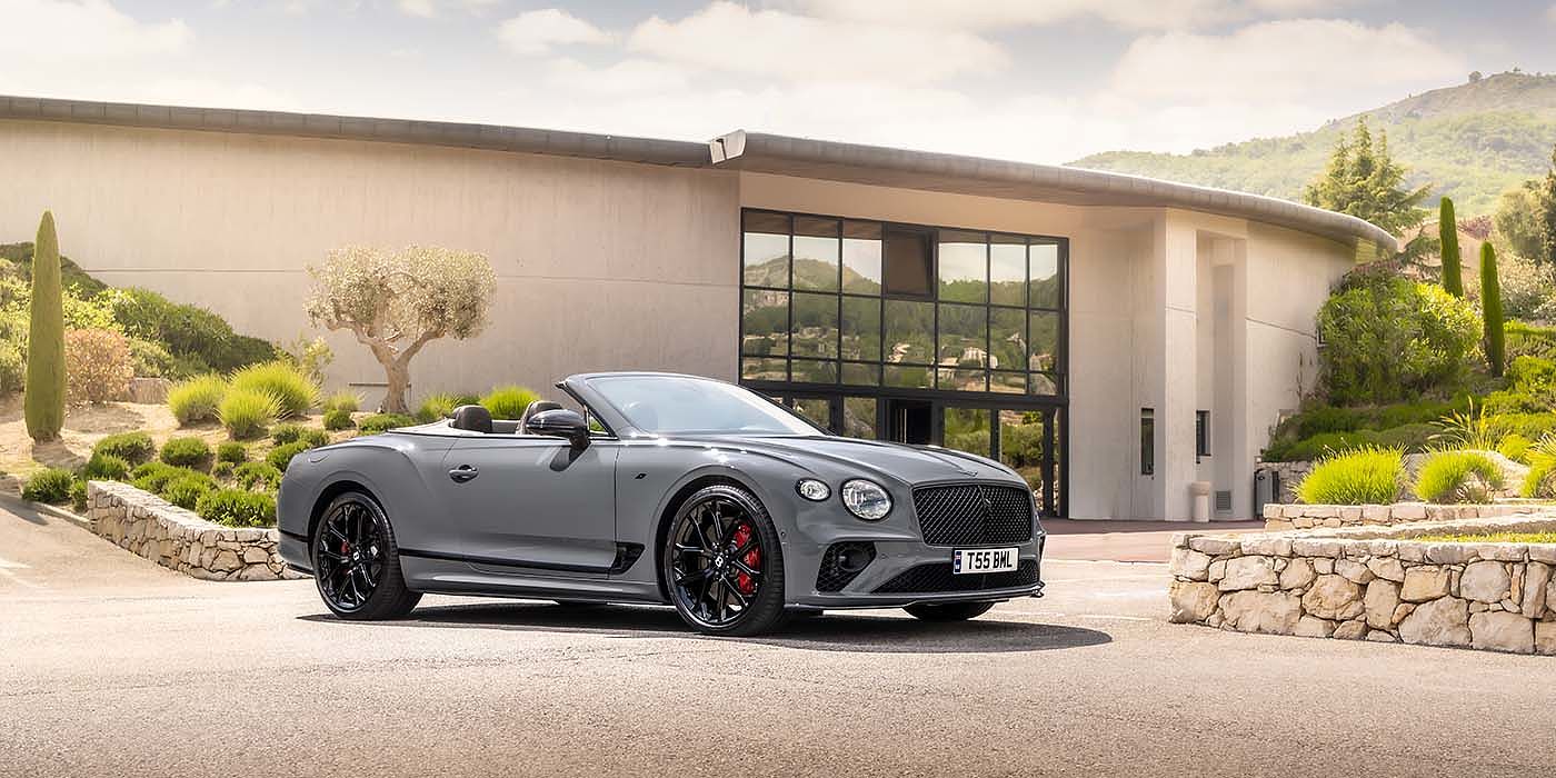Bentley Praha Bentley Continental GTC S convertible in Cambrian Grey paint front 34 static near house