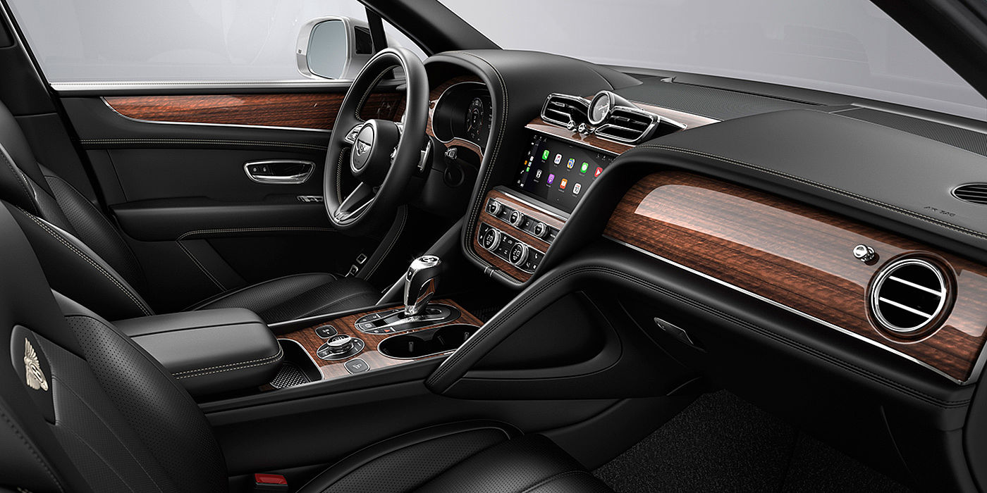 Bentley Praha Bentley Bentayga interior with a Crown Cut Walnut veneer, view from the passenger seat over looking the driver's seat.