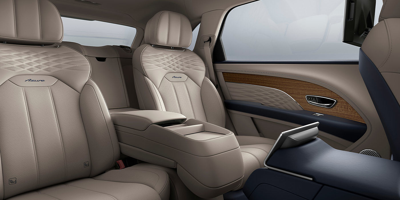 Bentley Praha Bentley Bentayga EWB Azure interior view for rear passengers with Portland hide featuring Azure Emblem in Imperial Blue contrast stitch.