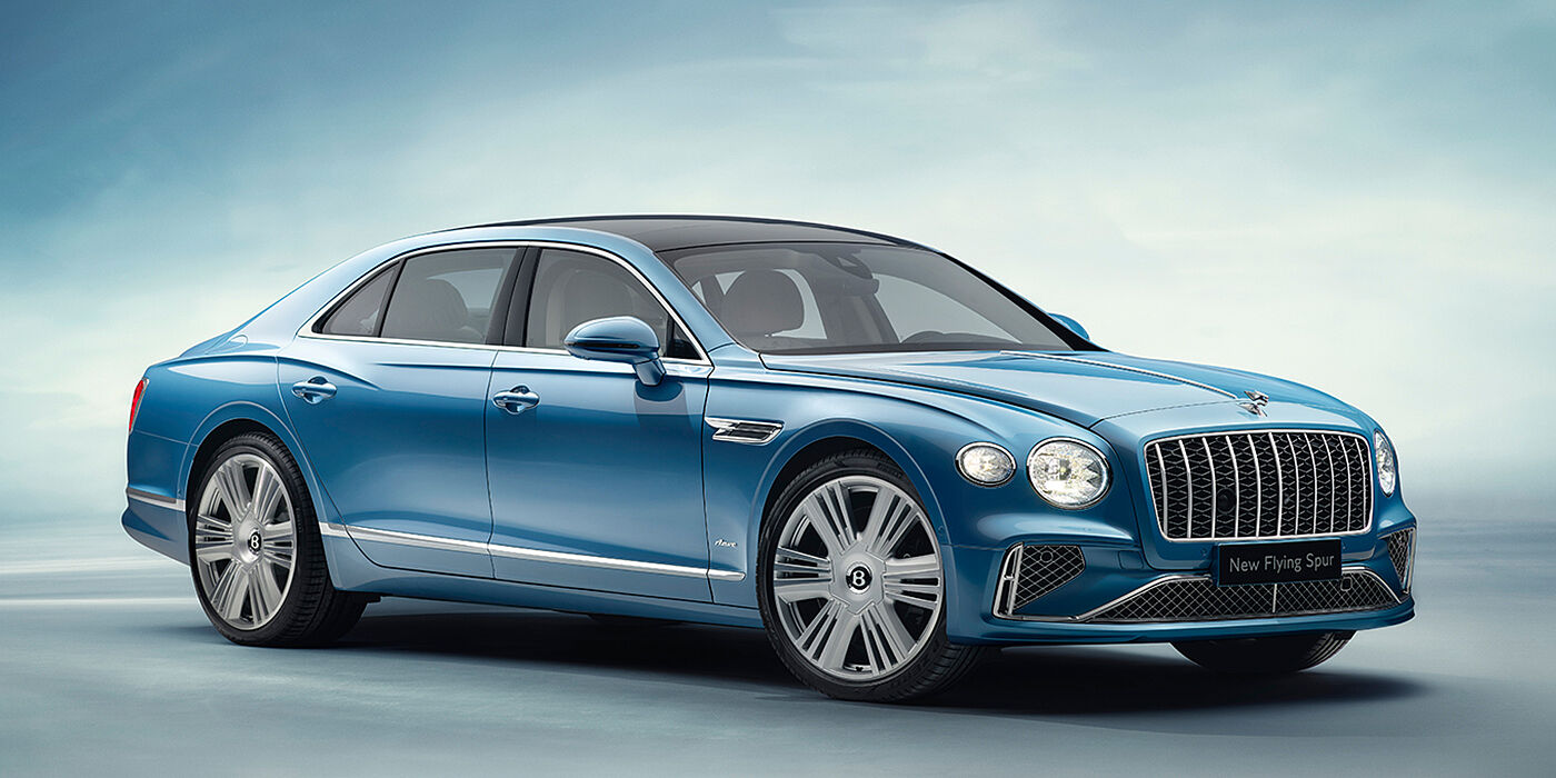 Bentley Praha New Bentley Flying Spur Azure sedan front view in Light windsor blue by Mulliner paint with 22 inch Azure wheels and chrome exterior details