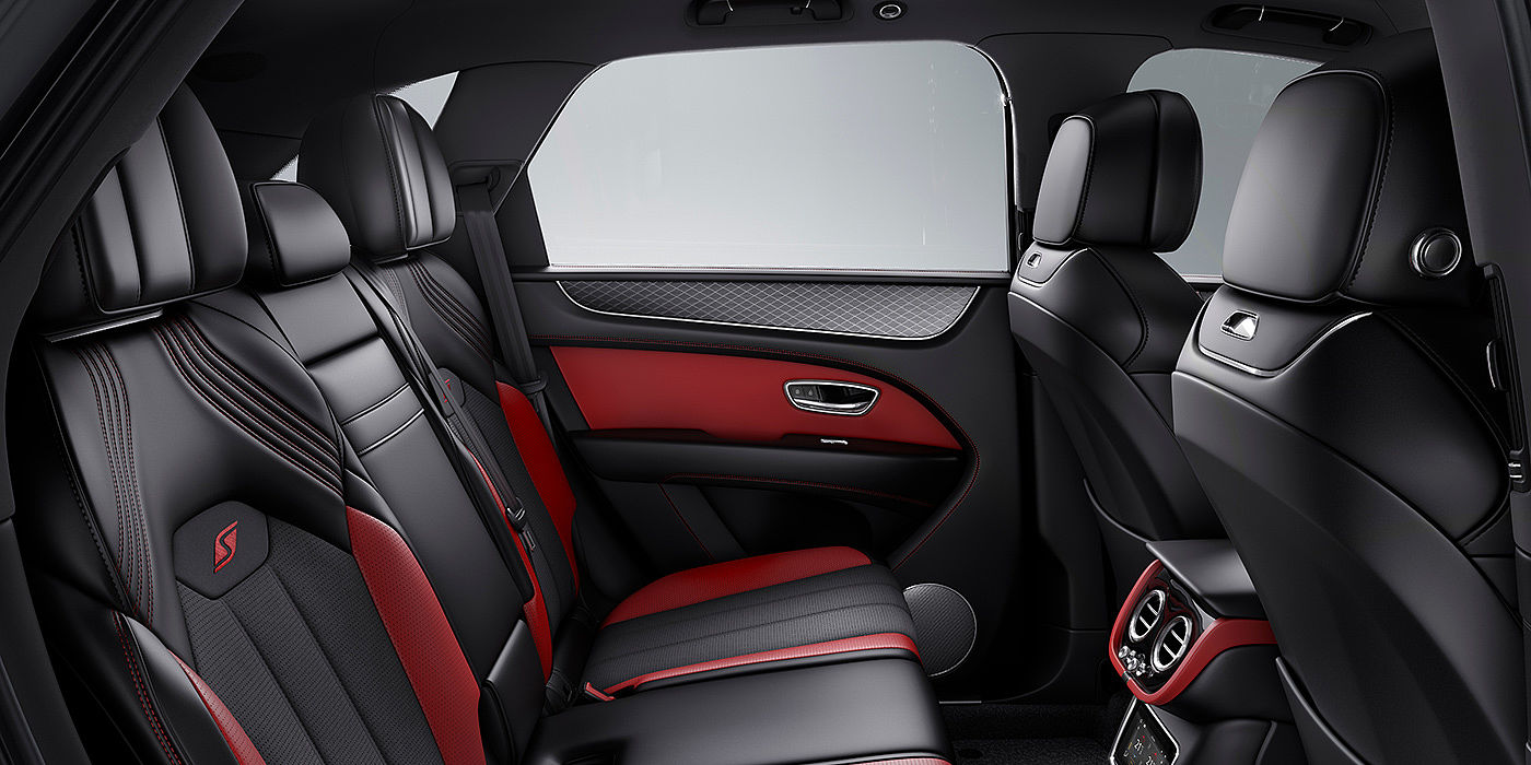 Bentley Praha Bentey Bentayga S interior view for rear passengers with Beluga black and Hotspur red coloured hide.