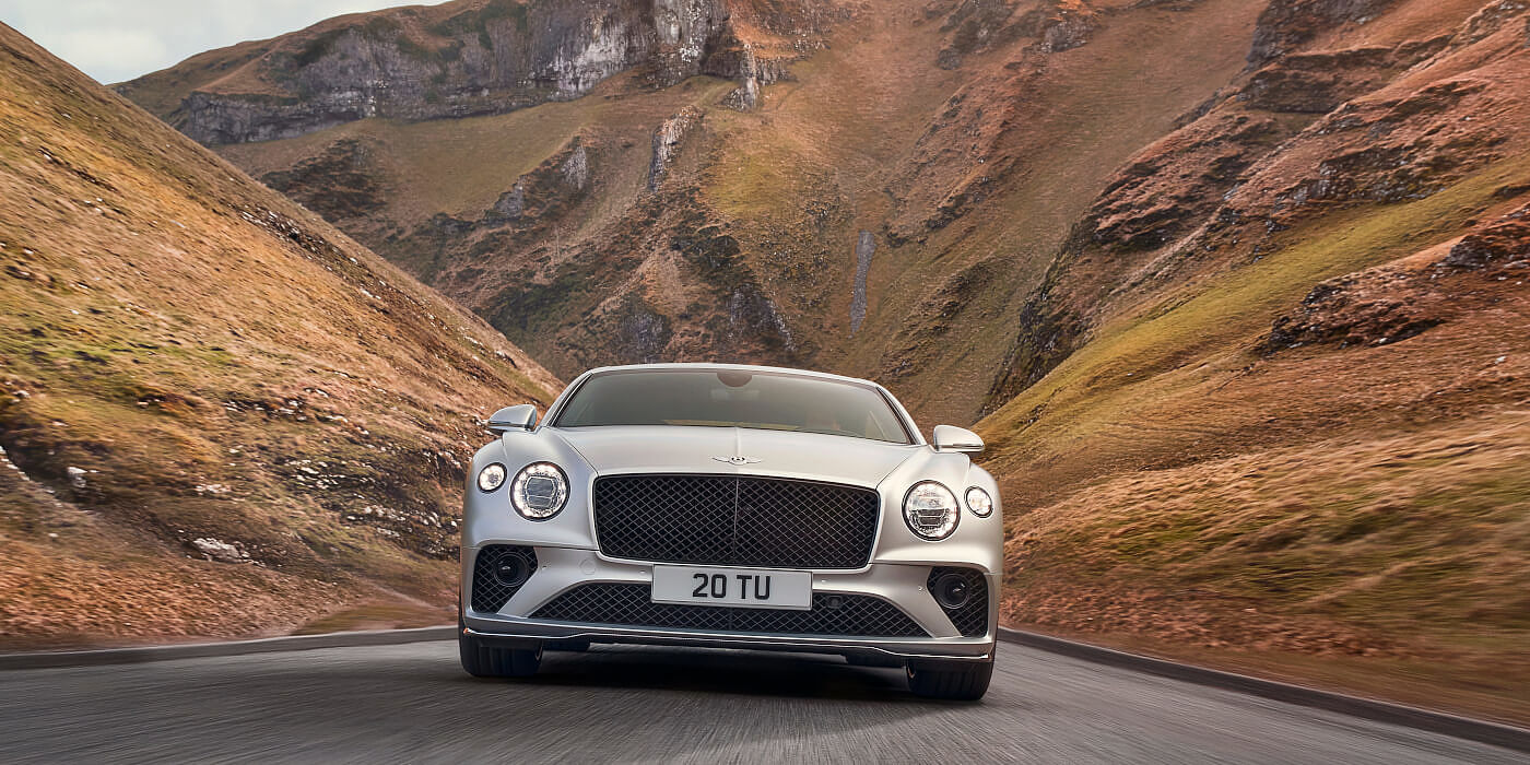 <new-bentley-continental-gt-speed-in-satin-silver-by-mulliner-paint-front-view-peak-district>
