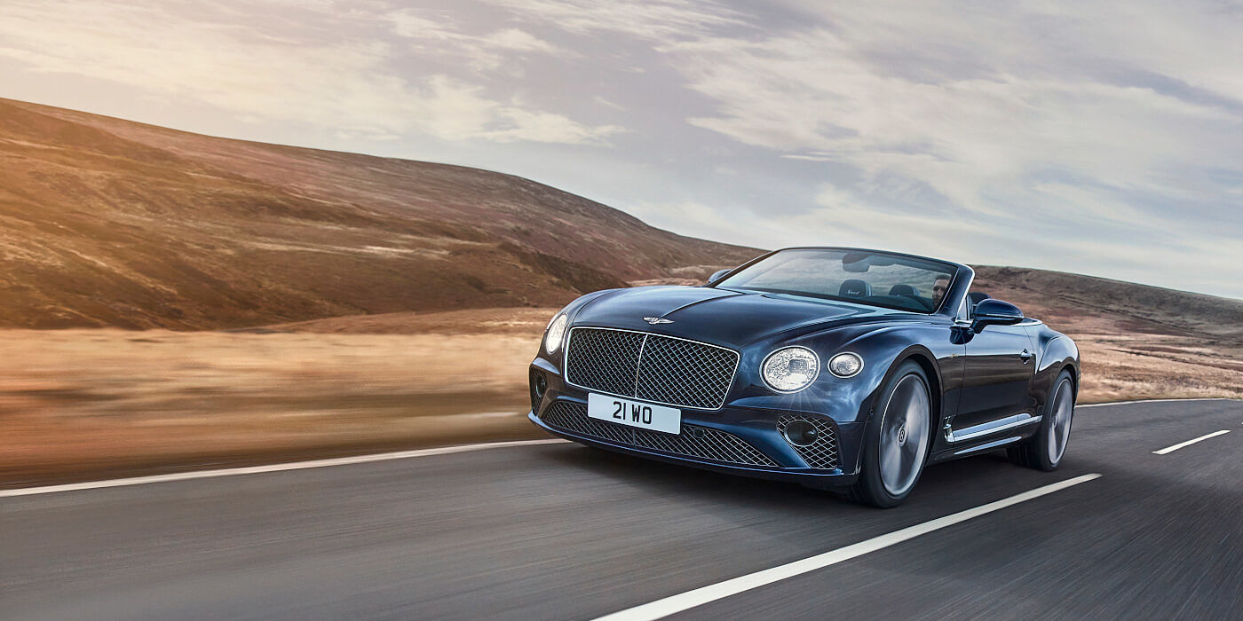 Bentley Praha Bentley Continental GTC Speed convertible in Peacock paint side front 34 dynamic