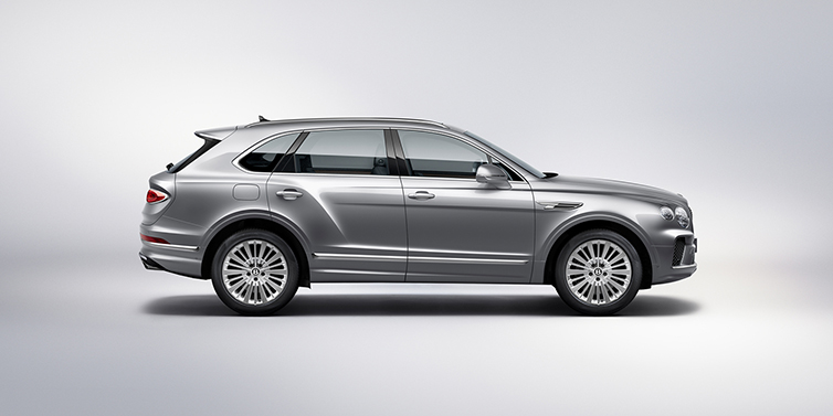Bentley Praha Bentley Bentayga SUV side profile in Moonbeam silver paint against white background featuring 21 inch 5 spoke wheels